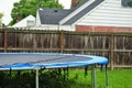 Dangerous live downed power line draped across fence and trampoline Royalty Free Stock Photo