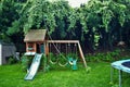 Dangerous live downed power line draped across trampoline and backyard playground Royalty Free Stock Photo