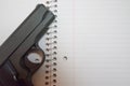 Loaded 9mm Handgun on Spiral Notebook