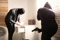 Dangerous masked criminals with weapon stealing money