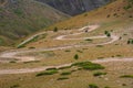 Dangerous mountain gravel road with off-road vehicle riding on it. Summer road trip, journey. Way to Burkhan-Bulak waterfall Royalty Free Stock Photo