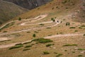 Dangerous mountain gravel road with off-road vehicle riding on it. Summer road trip, journey. Way to Burkhan-Bulak waterfall Royalty Free Stock Photo