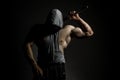 Dangerous muscular man in the mask with baseball bat ready for fight. An aggressive hooded man is holding a baseball bat Royalty Free Stock Photo