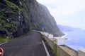 Dangerous part of the old road with rockfall in the fog. Coast of the island of Madeira.