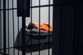 A dangerous prisoner in a cell rests and sleeps in a solitary cell on a bunk in an orange robe.