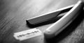 A dangerous razor and a metal blade on the table. Men`s shaving Royalty Free Stock Photo