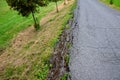 Dangerous road cracked and torn by frost and poor construction. to the road edge which can break off with a heavy vehicle bus and