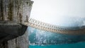 Dangerous rope bridge connecting two opposite sides. 3D illustration Royalty Free Stock Photo