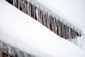 Dangerous sharp icicles and snow hanging from the roof