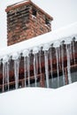 Dangerous sharp icicles and snow hanging from the roof