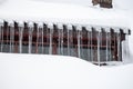 Dangerous sharp icicles and snow hanging from the roof