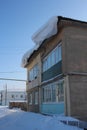 dangerous snowdrift hung over the house broke the visor will fall in winter untreated roof