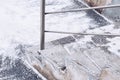 Dangerous stone staircase with metal handrails under the snow in winter Royalty Free Stock Photo