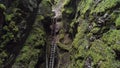 Dangerous trail through the deep gorge in green forest in the summertime. Stock footage. Top aerial view of the steep Royalty Free Stock Photo