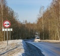 Dangerous turn with car on country road among trees