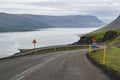 Dangerous winding downhill road with warning signs in Iceland with a motion blur effect