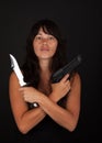 Dangerous woman holding knife and gun