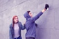 Dangerous young guy coloring city walls with spray paints Royalty Free Stock Photo