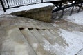 dangerously frozen stairs to the river. splash of water freezing on the Royalty Free Stock Photo