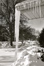 Dangerously huge icicle hanging from an eavestrough Royalty Free Stock Photo