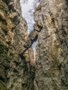A dangerously overhanging rock in a crevice between the rocks Royalty Free Stock Photo