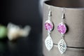 Dangle earrings made of epoxy resin and dried rose petals Royalty Free Stock Photo