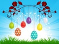 Dangling Easter eggs on blue sky landscape