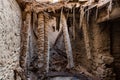 Dangling roof beams of abandoned house in ruins of Birkat al Mawz, Oman