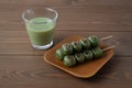 dango mugwort dumpling rice cake Japanese confectionery matcha green milk tea isolated on table Royalty Free Stock Photo