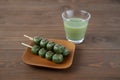 dango mugwort dumpling rice cake Japanese confectionery matcha green milk tea isolated on table Royalty Free Stock Photo