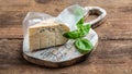 Danish blue cheese. Tasty blue cheese on a wooden background and burlap. Dorblu cheese pieces. Long banner format