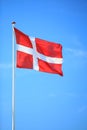 Danish flag with blue sky on background Royalty Free Stock Photo