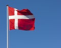 The Danish flag, Dannebrog, against a blue sky