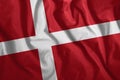 The Danish flag flutters in the wind. Colorful, national flag of Denmark. Patriotism, a patriotic symbol