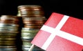 Danish flag waving with stack of money coins Royalty Free Stock Photo