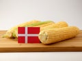 Danish flag on a wooden panel with corn isolated on a white back Royalty Free Stock Photo