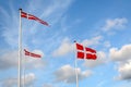 Danish flags Dannebrog in the wind at beach near Copenhagen, National symbol for the country of Denmark Royalty Free Stock Photo