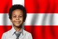 Danish kid boy on flag of Denmark background. Education and childhood concept Royalty Free Stock Photo