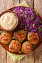 Danish meatballs frikadeller served with stewed red cabbage garnish close-up in a plate. vertical top view Royalty Free Stock Photo