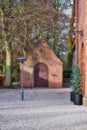 Danish national church with uncultivated hardwood forest trees and plants around it and in the backyard. Red facebrick Royalty Free Stock Photo