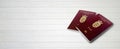 Danish Passports on Wood Lines Background Banner with Copy Space - 3D Illustration Royalty Free Stock Photo