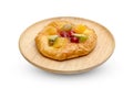 Danish pastry with fruits in wooden dish isolated on white background ,include clipping path Royalty Free Stock Photo