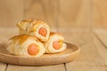 Danish Pastry with sausage on wooden dish Royalty Free Stock Photo