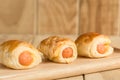 Danish Pastry with sausage on wooden dish Royalty Free Stock Photo