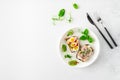 Danish smorrebrod open sandwiches on white plate, fork and knife, green salad leaves on white background. Top view Royalty Free Stock Photo