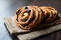 Danish Spiral Cinnamon Raisin Roll / German Pastry Schnecken on Sack. Royalty Free Stock Photo