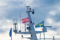 Danish and swedish flags on a top mast of a fishing trawler.. Royalty Free Stock Photo