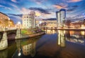 Danube Canal of Vienna, Austria. At the right the new UNIQA-Tower and opposite the historic building Urania. Royalty Free Stock Photo