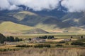 Traditional Tibetan countryside with fields and mountains around Daocheng Royalty Free Stock Photo