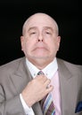 Dapper businessman fixing tie